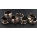 A group of seven mixed silver napkin rings, of varying size, design age and maker, gross weight