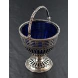 A George III silver sugar basket, having a bead moulded over handle over the bead moulded rim and