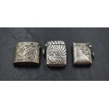 A group of three silver vesta cases, each of traditional design but smaller than normal proportions,