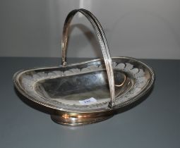 A Georgian silver table basket having leaf and scallop shell etched decoration and swing handle,