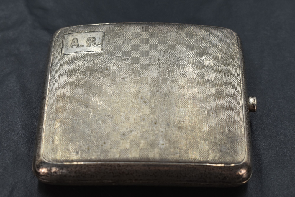 A 1920's silver cigarette case, of hinged rectangular form and curved for the gentleman's pocket,