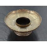 A Chinese white metal bowl, of lotus form with upturned petals engraved with repeating decoration