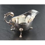 An early 20th century silver sauce boat, of traditional design with shaped rim and generous spout,