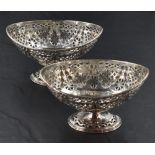 A pair of late Victorian silver pedestal dishes, of oval form with pierced diaper and embossed
