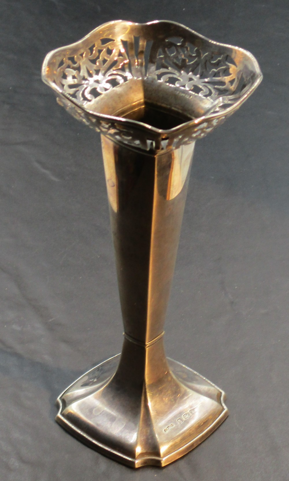 A 1920's silver spill vase, of tapering square section form with shaped and pierced rim, the base