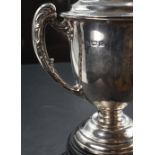 A George V silver trophy, of typical twin handled and lidded form with engraved inscription 'Suffolk