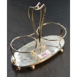 A late Victorian silver bottle stand, having a central shaped and pierced handle between two