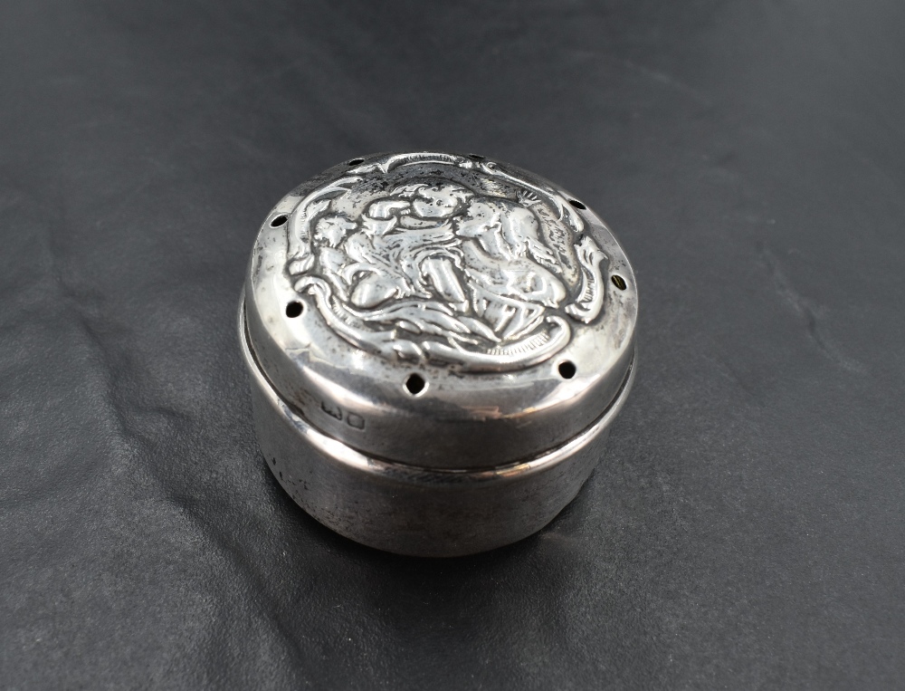 An Edwardian silver baby powder caster, of cylindrical form, the cover pierced and embossed with a