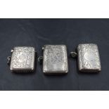 A group of three silver vesta cases, each with engraved foliate decoration, all Birmingham,