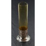 A silver and glass stem vase having cylindrical amber glass vase in a moulded silver base,