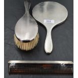A 1960's silver three-piece dressing table set, comprising hand mirror, hair brush and comb of
