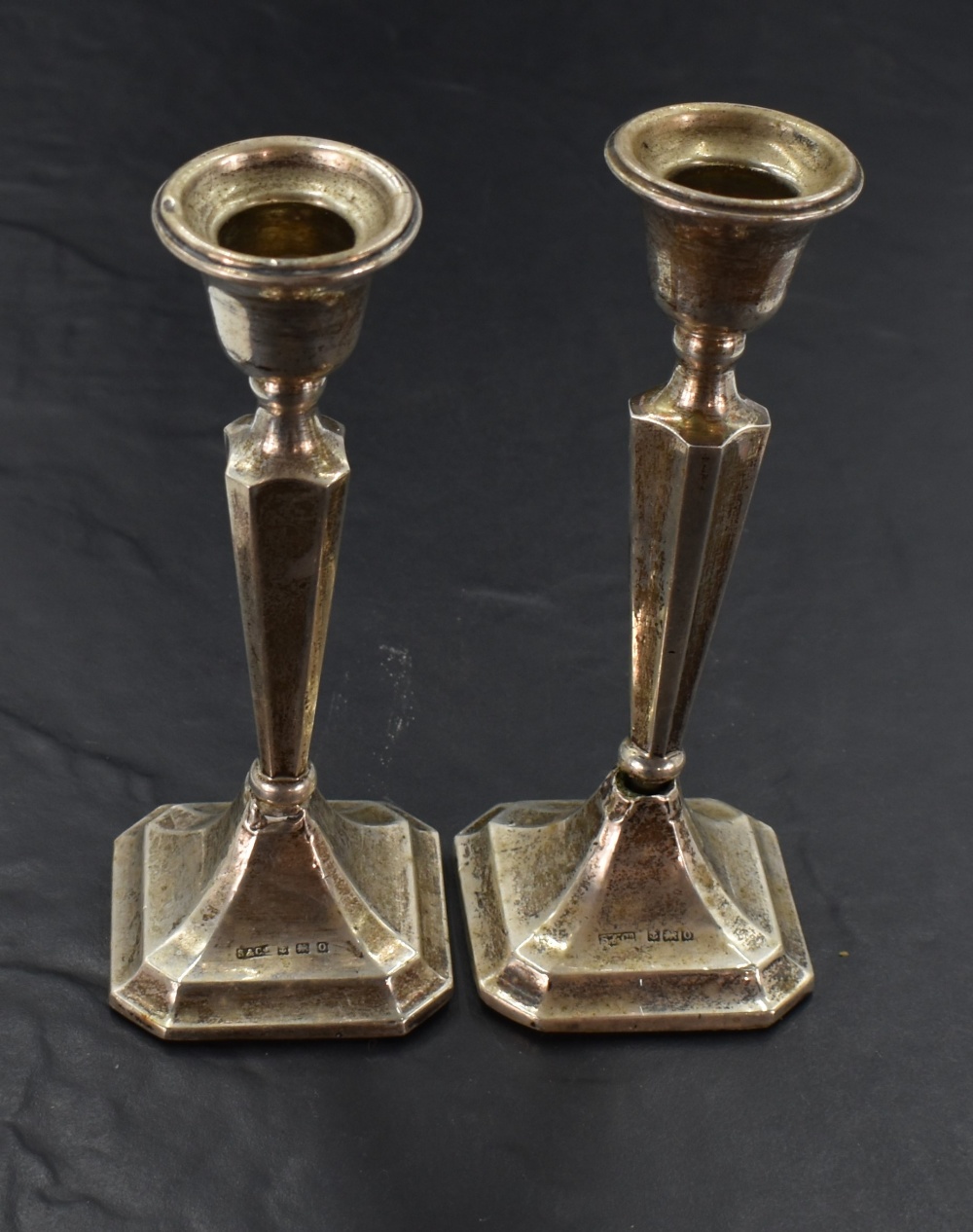 A pair of silver candlesticks, of fluted and tapering form, marks for Birmingham 1913, maker S&Co