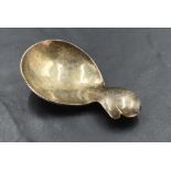 An Elizabeth II silver caddy spoon, having broad oval bowl and short trefoil handle, marks for