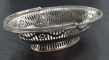 A Georgian silver sweetmeat basket of boat form having pierced and bright cut decoration, beaded