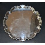 An Elizabeth II silver salver, of circular form with moulded 'Chippendale' design rim enclosing an