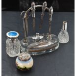 A 1930's silver and glass table top manicure set, the oval clear glass platform with recessed