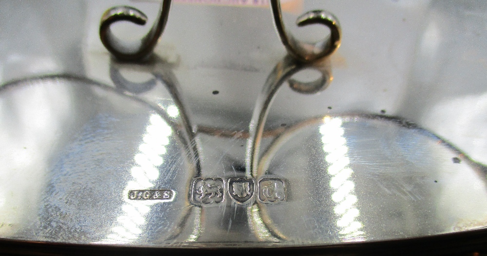 A late Victorian silver bottle stand, having a central shaped and pierced handle between two - Image 2 of 2