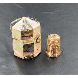 A yellow metal thimble, of traditional design, engraved with initials and marked '9' 5.3grams,