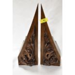 A heavy pair of 1920s/ 30s book ends with foliate carved frontages and slate to back.