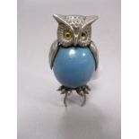 A mid century novelty retracting tape measure in the form of an owl.