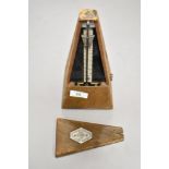 An antique Paquet musicians metronome