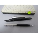 A Parker fountain pen and retracting pencil set in box, both having black barrels with brushed steel