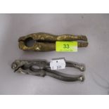Two antique nut crackers, one in the form of a pair of nude female legs.