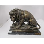 A Victorian cast bronze or bronzed metal study of a lion with boar, on marble base.