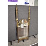 A mid Victorian Pugin style mirror , having decorative finials to sides with mirrored inserts in a