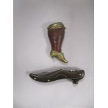 An antique brass and leather vesta case in the form of a Victorian shoe and leg, and a pocket