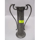 An Art Nouveau pewter vase with Planished finish and shaped handles with flower motifs impressed