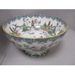 A large early 20th century Royal Doulton 'Birds of paradise' footed bowl, AF , damage to base.