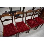 A set of four Victorian mahogany rail back dining chairs having bergere seats under red velvet