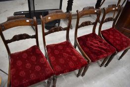 A set of four Victorian mahogany rail back dining chairs having bergere seats under red velvet
