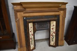 A Victorian style cast , tiled and stripped wood fire surround
