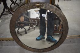 A vintage brass framed circular wall mirror