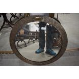 A vintage brass framed circular wall mirror