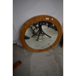 A vintage wood laminate circular wall mirror