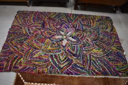 A vintage multi colour pegged rug