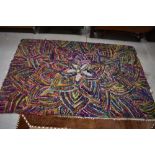 A vintage multi colour pegged rug