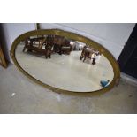 A vintage brass framed wall mirror