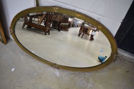 A vintage brass framed wall mirror