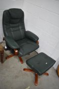 A modern green leather easy chair and footstool, similar to stressless