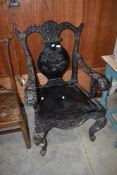 An interesting Oriental throne style carver chair having extensively carved dragon decoration