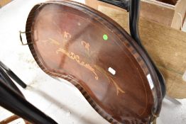 An early 20th century large kidney shaped tray having painted design and edging and brass handles.
