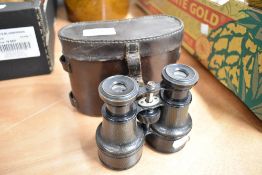 A pair of early 20th century binoculars with leather case