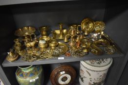 A good selection of brass wares including an antique goat figure study, door bells and candlesticks