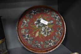A Victorian button form foot stool with bead worked top