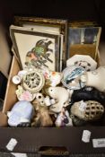 A box of miscellaneous ornaments and framed pictures.
