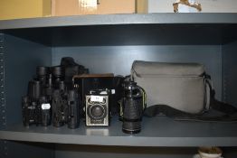 Four pairs of modern binoculars including Miranda 8x40 and a Brownie camera